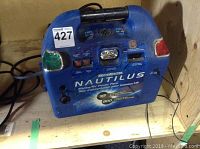 Front view of the Motomaster Nautilus Marine/RV Power Pack showing buttons, indicator lights, flashlight and branding.