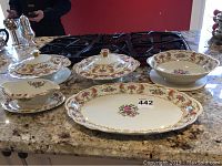 Full set of five Royal Bayreuth Bavaria porcelain serving pieces on granite countertop including two covered bowls, a serving bowl, platter, and gravy bowl.