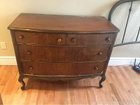 Front view showing overall dresser, drawer layout, and legs.