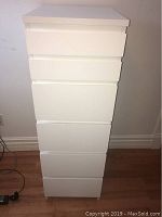 White IKEA Malm tall dresser with six drawers, front view showing all drawers closed.