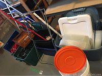 Plastic storage bins containing baskets, plastic containers, and assorted items