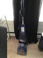 Full front view of the Bissell Quicksteamer Powerbrush upright carpet cleaner showing overall shape and features.