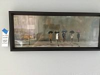 Framed Max Moran umbrella figures art print showing entire artwork horizontally hung on a light colored wall.