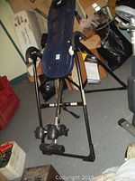 Teeter Hang Ups inversion table assembled upright with blue mesh backrest and black frame