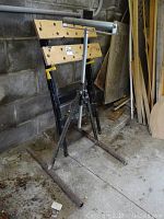 Work bench and rolling rest shown side by side against a concrete block wall in a workshop setting.
