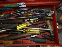 Close-up photo of drawer with numerous screwdrivers, hammer and punches
