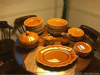 Full set displayed on wooden table, includes all listed dinnerware items