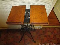 Top view of the adjustable wooden platforms of the book stand, showing wood grain and some marks.