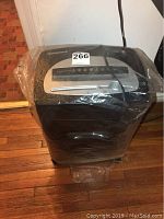 Front angled view of Honeywell shredder wrapped in plastic, showing overall condition and design