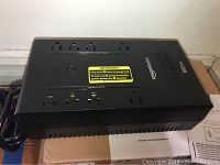 Top view of Amazon Basics 600VA UPS showing power outlets and labels