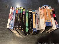 Top view of the DVD and VHS collection showing 15 titles in lineup on table.