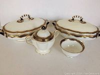 Photo displaying all four items: two covered serving dishes, sugar bowl with lid, and a cup, showing overall lot composition and decoration.