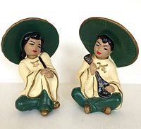 Front view of the pair of vintage plaster figures, showing their color and seated poses
