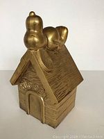 Front view showing Snoopy lying on doghouse with 'SNOOPY' engraving on front.