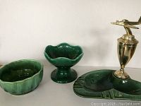 Photo showing all three pottery pieces together: small bowl, pedestal bowl, and divided tray with airplane.