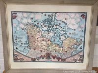 Overall view of framed Canada map print showing frame and mat