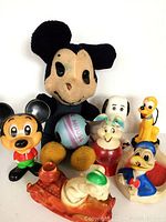Overview of all eight vintage toys together including plush Mickey Mouse and smaller figures