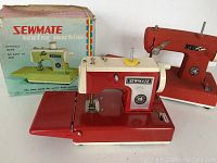 Two vintage Sewmate toy sewing machines pictured with original box for one unit