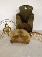 Photo showing all four metal letter holders in a group, highlighting the variety in designs and finishes.