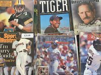 Photo showing 7 sports magazines including Beckett Football Card, Tiger, Sports Illustrated with Dale Earnhardt, Sports Illustrated with Barry Bonds, Beckett Baseball Card Monthly with Padres player and #55 player covers.
