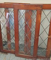Four wooden framed lead glass doors with diamond-pattern leaded glass inside, showing overall look and finish.
