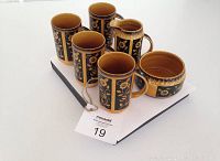 Full set of 4 mugs, milk pitcher/creamer, and sugar bowl arranged on white base with label visible