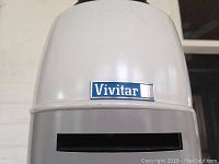 Close-up photo showing white lamp housing of the enlarger with Vivitar logo.
