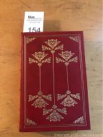 Front cover showing red leather with elaborate gilt tooling decoration.