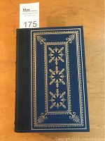 Front cover showing dark blue cover with elaborate gilt tooled design.