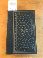 Front cover of the book showing dark blue leather with gold gilt tooling in diamond and fleur-de-lis pattern.