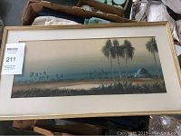 Full view of the framed watercolour desert landscape painting showing palms, dome structure, signature, and mat, with MaxSold lot number attached.