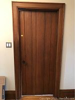 Full front view of oak door installed in jamb