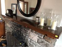 Full view of oak mantle installed above stone surround