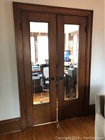 Full view of the pair of wooden French doors installed in frame