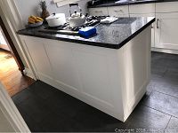 Full angle view of white base and granite top