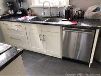 Full view of cabinet, countertop, sink and dishwasher cutout