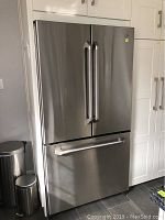 Full front view of stainless steel French door refrigerator with bottom freezer drawer.