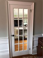 Full view of painted door installed in jamb against interior wall