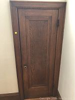 Front view of oak panel door installed in its frame