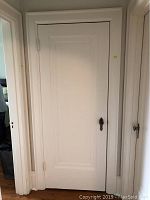 Full view of white painted door and jamb installed in wall opening