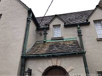 Front facade showing vertical copper downspouts and horizontal gutter section on sloped roof