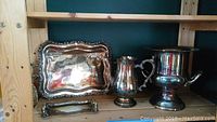 Photo showing all four items: rectangular tray, pitcher, ice bucket and butter dish on wooden shelf