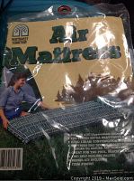 Photo of Northwest Territory air mattress packaging showing plaid mattress and repair kit included.