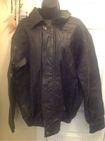 Front view of men's Cellini black leather jacket with snap button and zipper closure, size L.