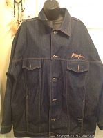 Front view of dark denim men's jean jacket by Phat Farm showing button closure and two chest pockets.