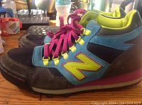 Side angle view of one sneaker showing construction, colors, and materials.