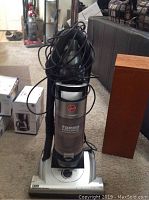 Front view of Hoover Turbo Cyclonic vacuum cleaner showing brand logo, cyclonic canister, and power dial