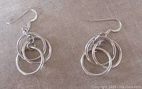 Top view of the two earrings showing three interconnected circular hoops forming a drop shape.