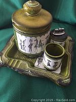 Photo of the full smokers set on a green background showing ashtray, jar, cup, and lighter with traditional Japanese design