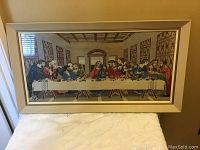 Full framed needlepoint of the Last Supper scene hanging on wall, measuring about 36 x 19 inches.